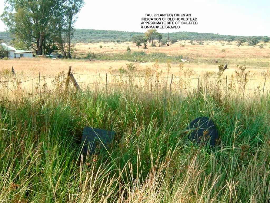 Unmarked graves in the isolated cemetery, at a distance (see arrow)
