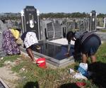 08.  Family cleaning grave in block 50